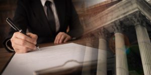 Attorney signing legal document with court background