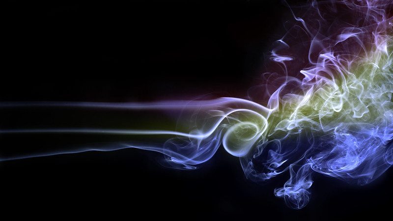 Photo demonstrating a turbulent flow of colored smoke.