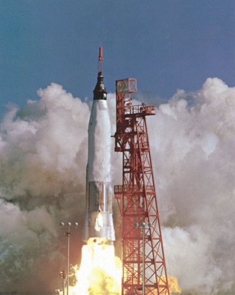 Photograph of a rocket launching up, leaving behind the red launch frame.