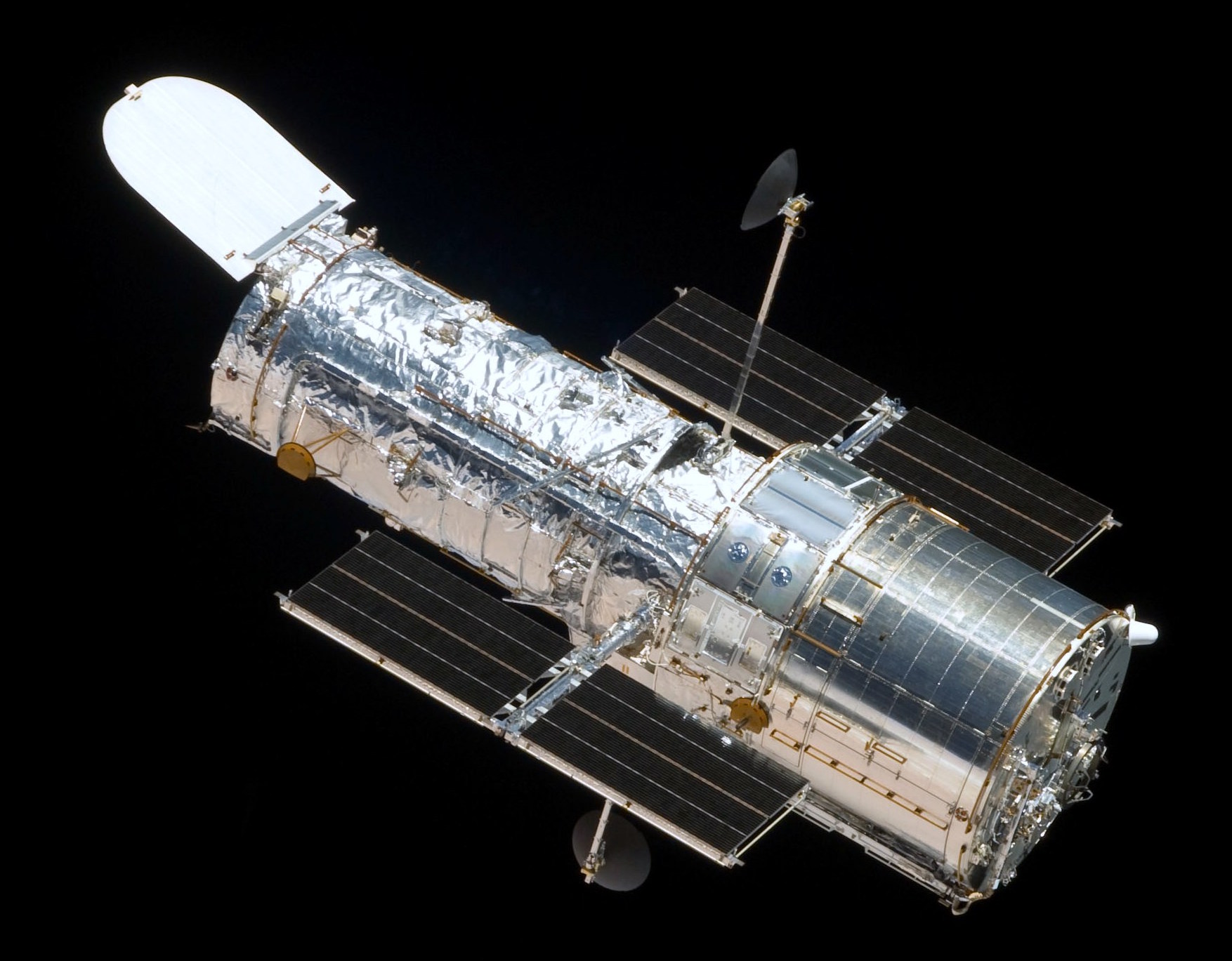 Photograph of the silver Hubble Space Telescope on a black background.