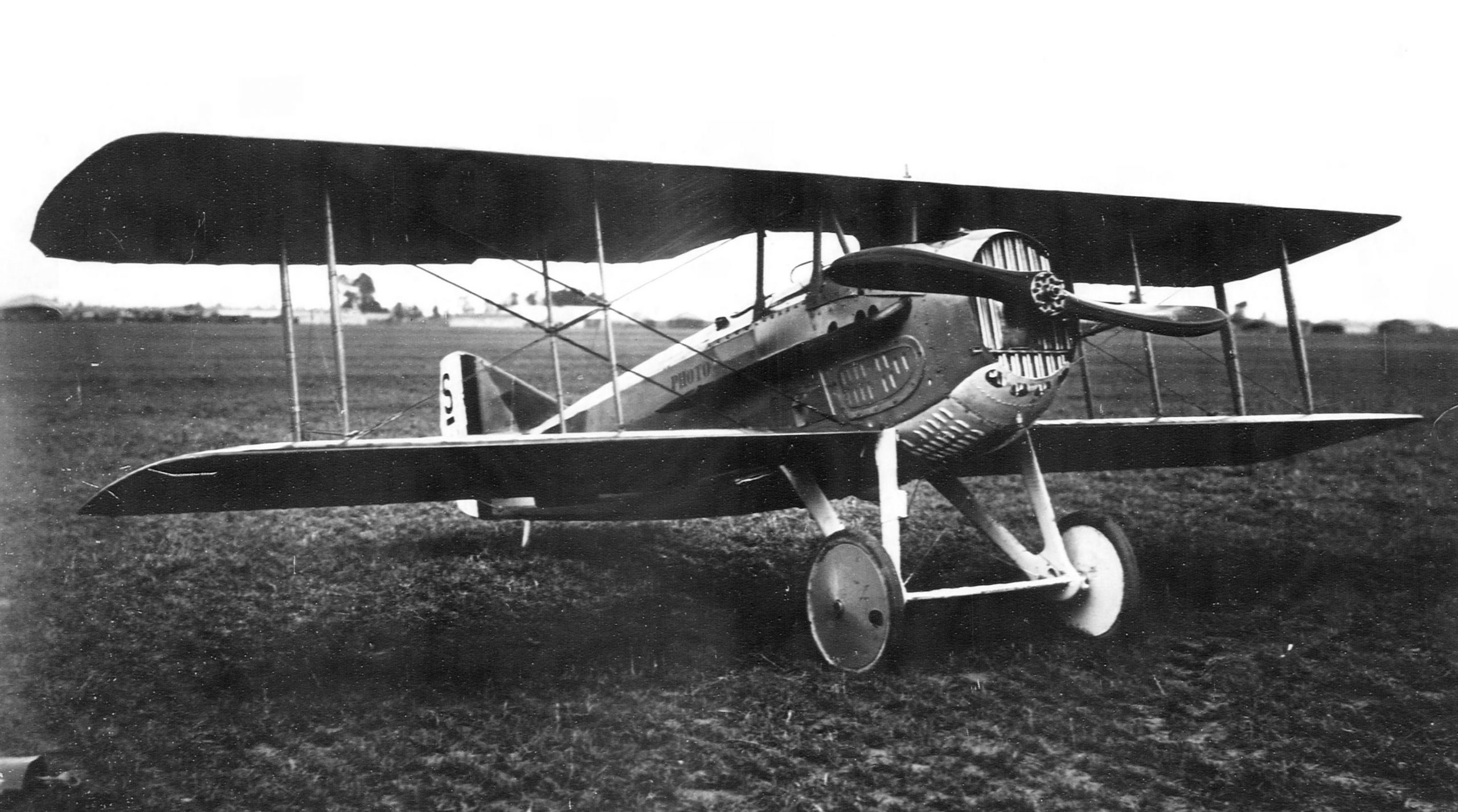 A black and white photograph of a biplane.