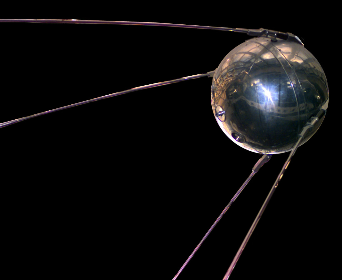 A photograph of a model of Sputnik on a black background.